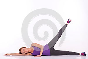 Healthy young sportswoman does the exercises