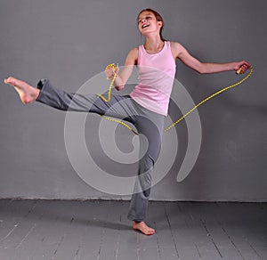 Healthy young teenage girl skipping with rope .