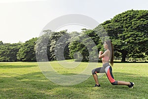 Healthy young teenage girl stretching arms workout and warmup before fitness training session in the park at Sunday morning. life