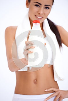 Healthy young woman with a bottle of milk