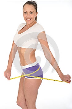 Healthy Young Woman Checking Her Weight Loss With a Tape Measure