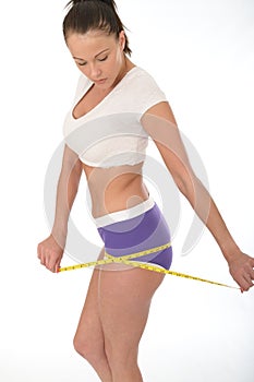 Healthy Young Woman Checking Her Weight Loss With a Tape Measure