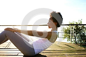 Healthy young woman doing abs crunches photo