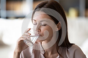 Healthy young woman drink pure mineral water