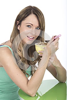 Healthy Young Woman Eating Bowl of Breakfast Cereals