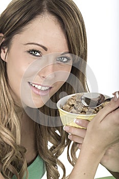 Healthy Young Woman Eating Bowl of Breakfast Cereals