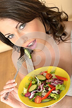 Healthy Young Woman Eating a Fresh Mixed Colourful Salad