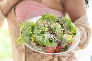 Healthy young woman eating green salad for healthy lifestyle food and bodycare beauty concept