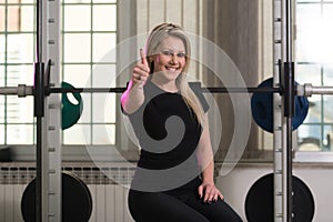 Healthy Young Woman Flexing Muscles