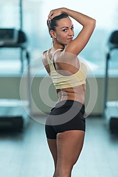 Healthy Young Woman Flexing Muscles