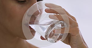 Healthy young woman holding glass drinking water keep hydration balance