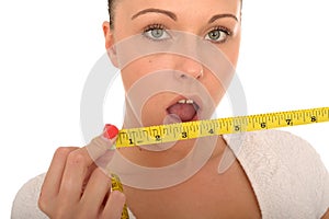 Healthy Young Woman Holding a Tape Measure with Shocked Expression