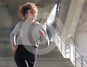 Healthy young woman running outdoors
