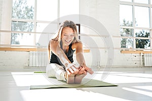 Healthy young woman warming up in gym