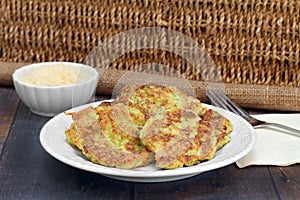 Healthy Zucchini Fritters with a side of parmesan cheese.