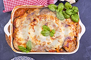Healthy zucchini lasagna bolognese in a baking dish with olive oil. Oven baked traditional Italian cuisine with