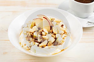 Healthy Î’reakfast concept. Yogurt with flakes, fruits and honey on wooden background