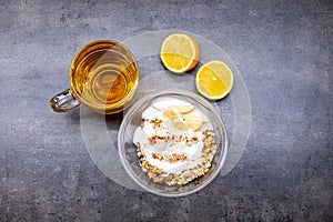 Healthyfood, granola with yogurt, pineaple and apple, tea with lemon. Heathy breakfast