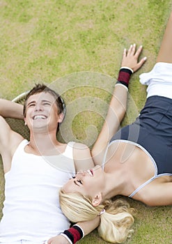 Healthylife Concept: Young Couple of tennis Players Resting On T