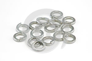 Heap of 8mm split spring washers on white background