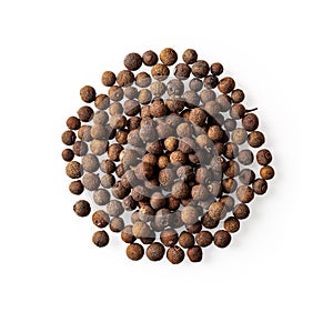 Heap of allspice pimento berries isolated on a white background. Pile of whole jamaica pepper grains cutout for food design.