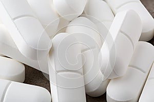 Heap of antibiotic white pills. Closeup photo