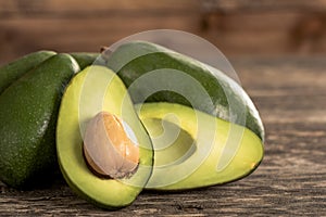 Heap of avocados on wooden table