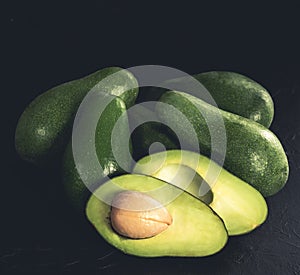 Heap of avocados on wooden table