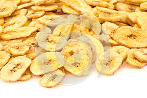 Heap of banana chips on white background