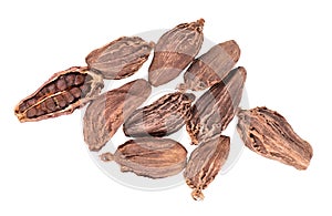 Heap of black cardamom pods isolated on white background. Black cardamon seeds. Clipping path. Top view.