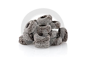 Heap of black cereal rings isolated on white background, delicious and useful rings breakfast cereal, view close-up