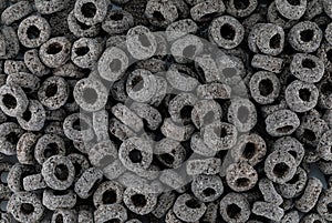 Heap of black cereal rings isolated on white background, delicious and useful rings breakfast cereal, view close-up