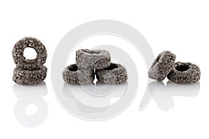 Heap of black cereal rings isolated on white background, delicious and useful rings breakfast cereal, view close-up