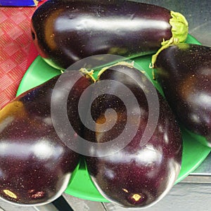 Heap of Brinjal on market .The name as called egg fruit, aubergine, Solanum melongena for sale in a vegetable