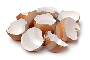 Heap of brown empty egg shells close up on white background