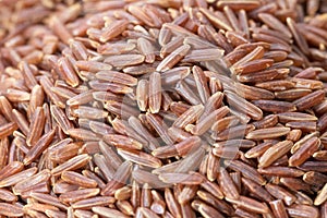 Heap of brown rice or red rice in macro view