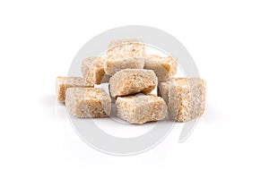 Heap brown sugar cubes isolated