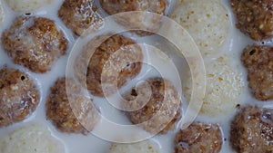 Heap of brown and white chocolate cereal balls on rotating surface - close up