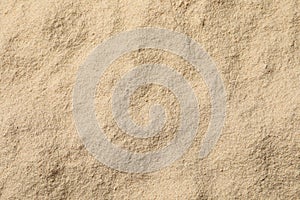 Heap of buckwheat flour as background, top view