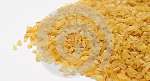 Heap of bulgur wheat groats isolated