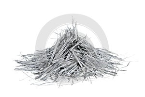 Heap of bundles of grey colored polypropylene fiber for concrete structural reinforcement, isolated on white background