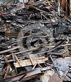 Heap of burned and scattered bricks beams and rubble after a fire in a large building