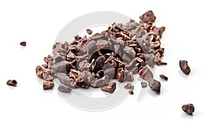 Heap of cacao nibs on white background