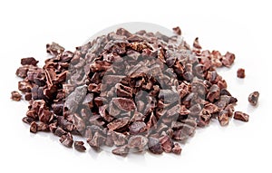 Heap of cacao nibs on white background