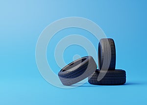 Heap of car rubber tyres on blue background