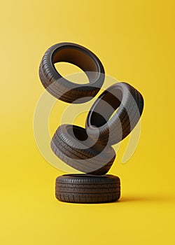 Heap of car rubber tyres on yellow background