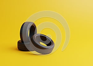 Heap of car rubber tyres on yellow background