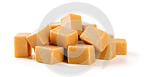 Heap of caramel vanilla fudge isolated on white background. Fresh tasty candies made of milk and sugar. Square pieces of delicious