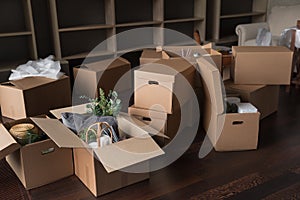 Heap of cardboard relocation boxes stacked on living room floor