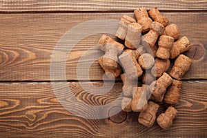 Heap of champagne corks over rustic wooden table background